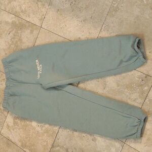 Large 'Love never fails' sweatpants